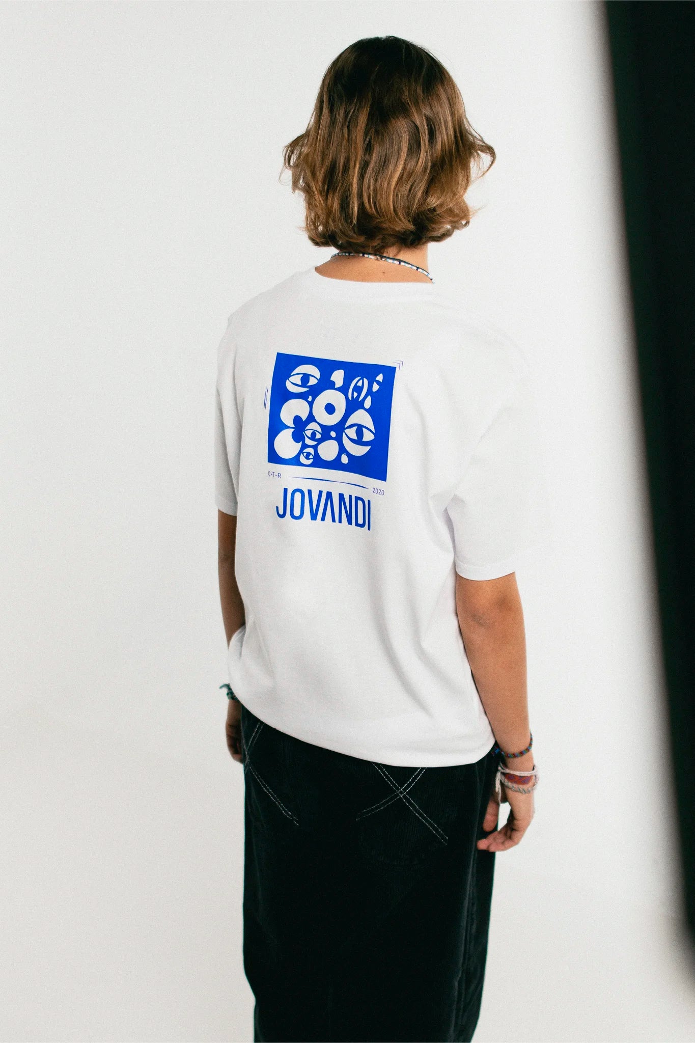 Woman wearing the white and blue Jovandi Cheyes1 T-Shirt