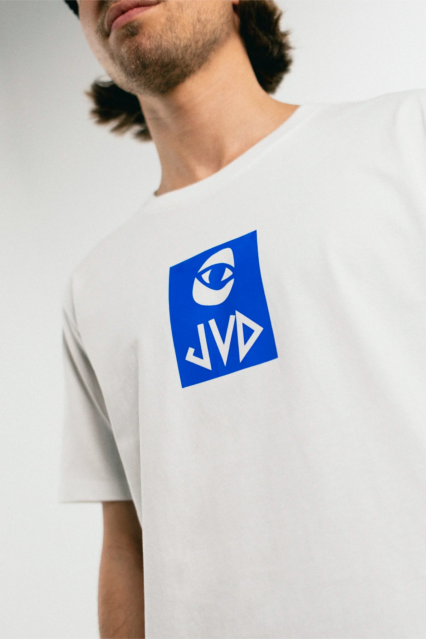 Man wearing the white and blue Jovandi Cheyes2 T-Shirt
