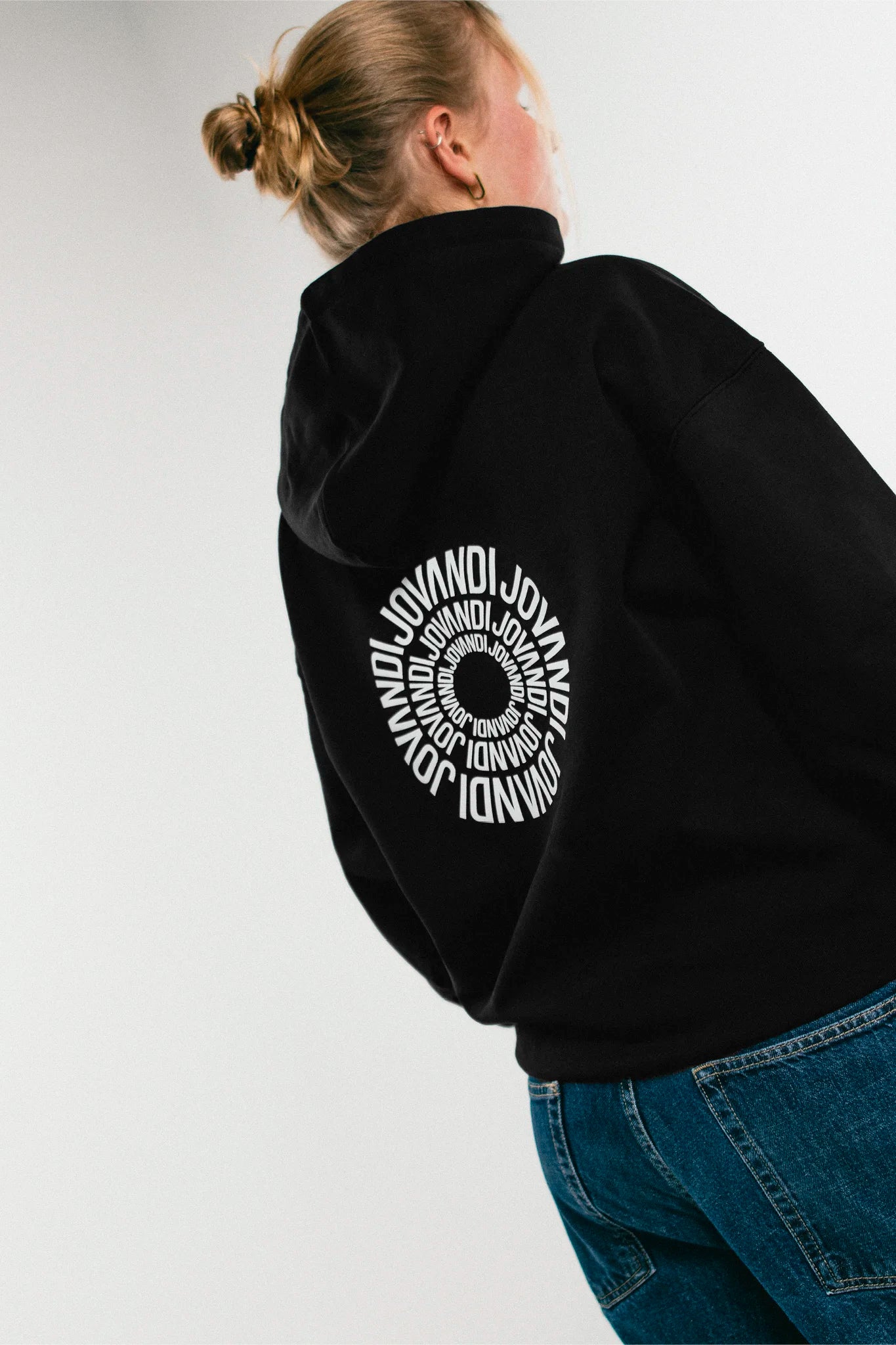 Woman wearing the black Jovandi circle hoodie