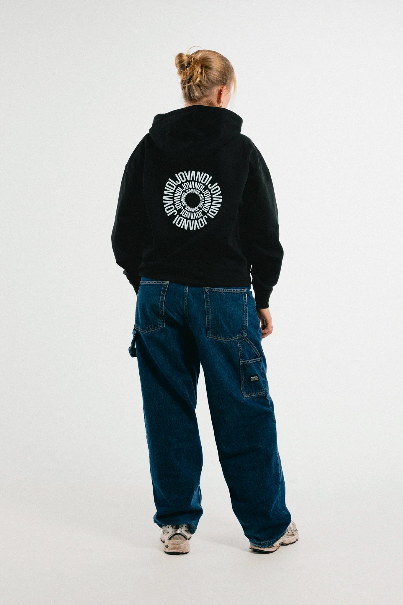Woman wearing the black Jovandi circle hoodie