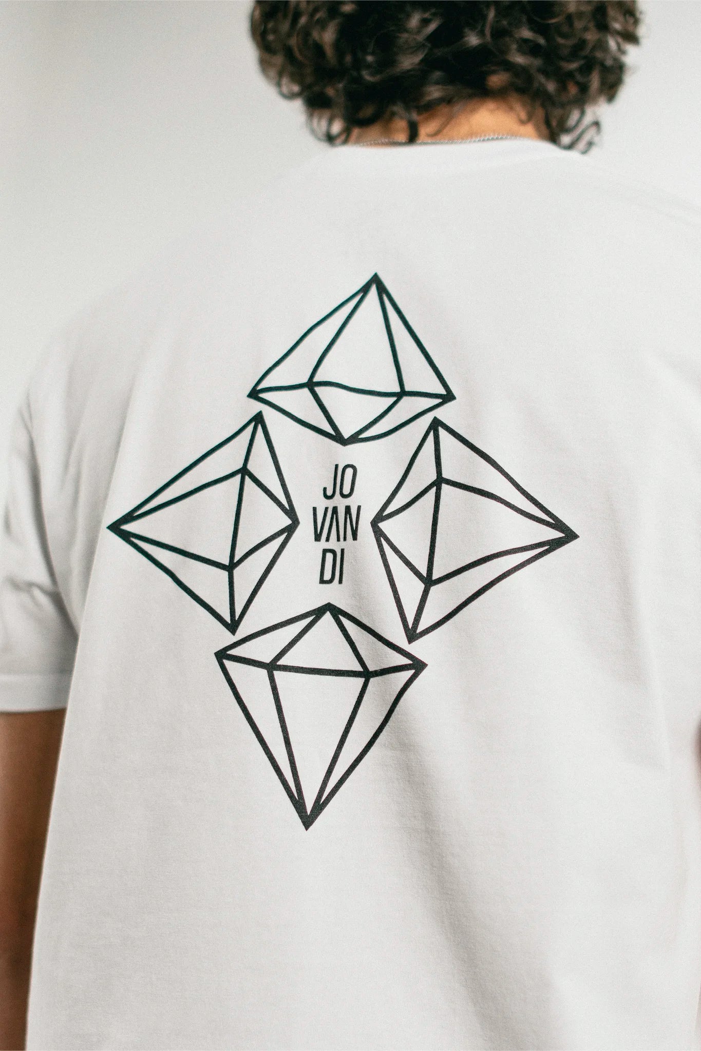 Closeup of the back print of the white Jovandi Diamonds T-Shirt
