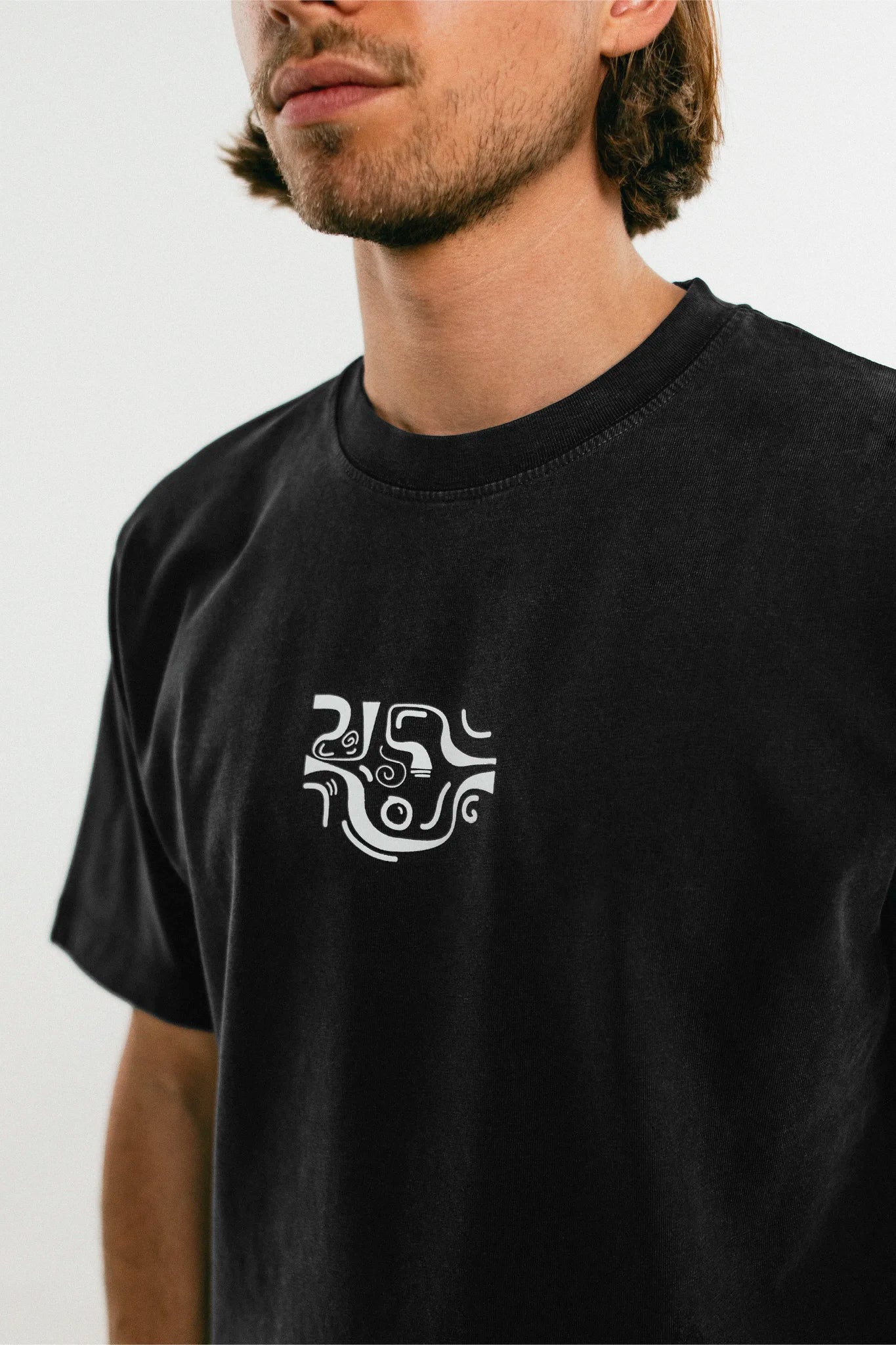 Man wearing the black Jovandi Drawn Lines T-Shirt