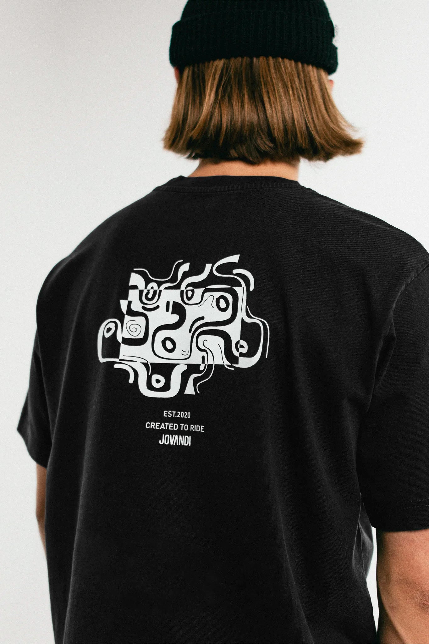 Man wearing the black Jovandi Drawn Lines T-Shirt
