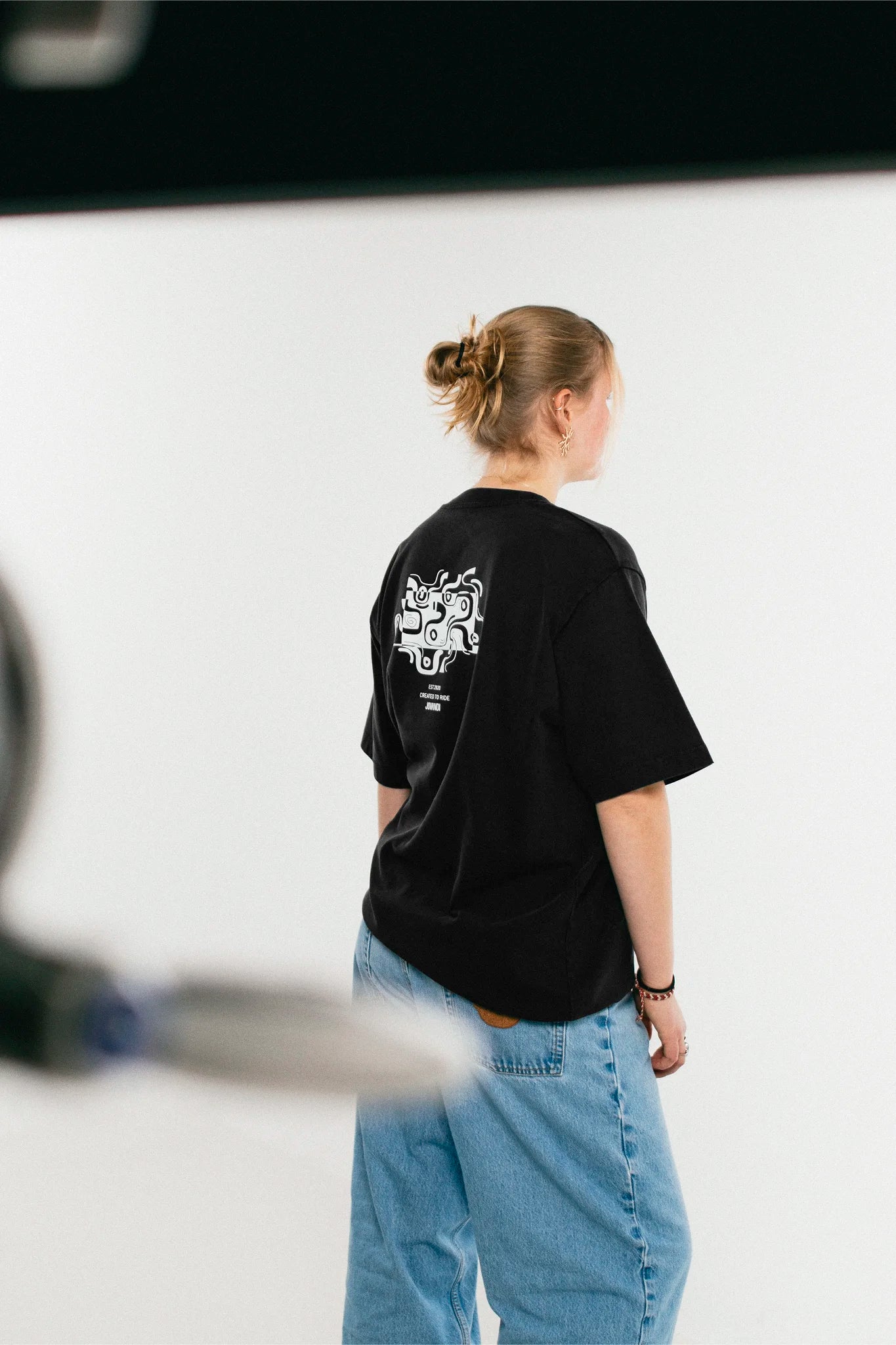 Woman wearing the black Jovandi Drawn Lines T-Shirt