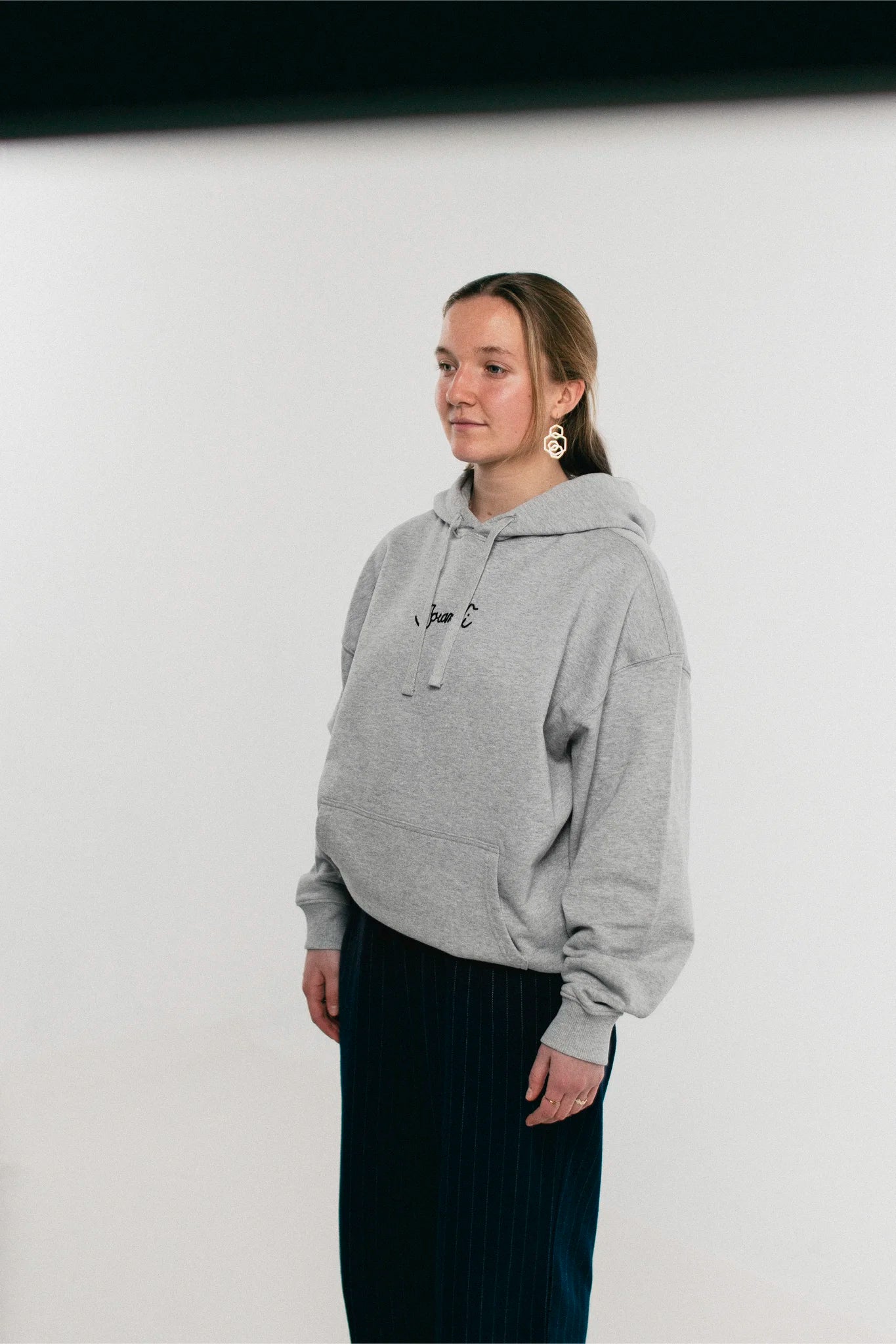 Woman wearing the heather grey Jovandi guitar hoodie