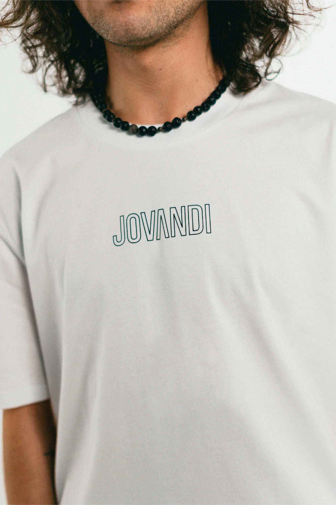 Man wearing the white Jovandi Lines T-Shirt