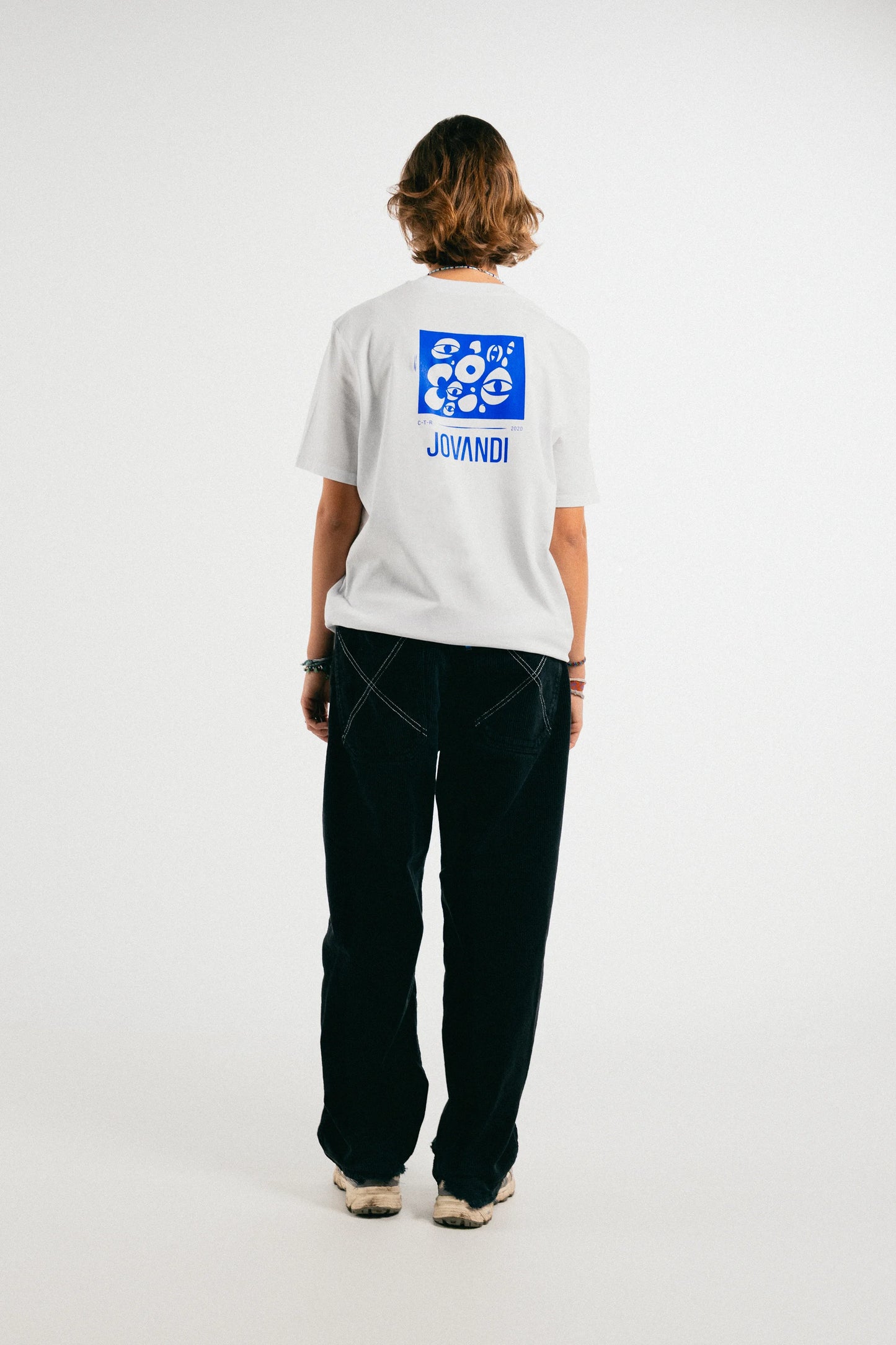 Woman wearing the white Jovandi Cheyes One T-Shirt