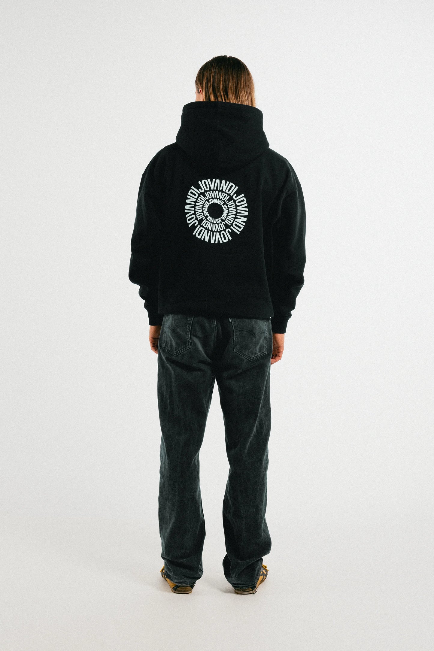 Man wearing the black Jovandi circle hoodie