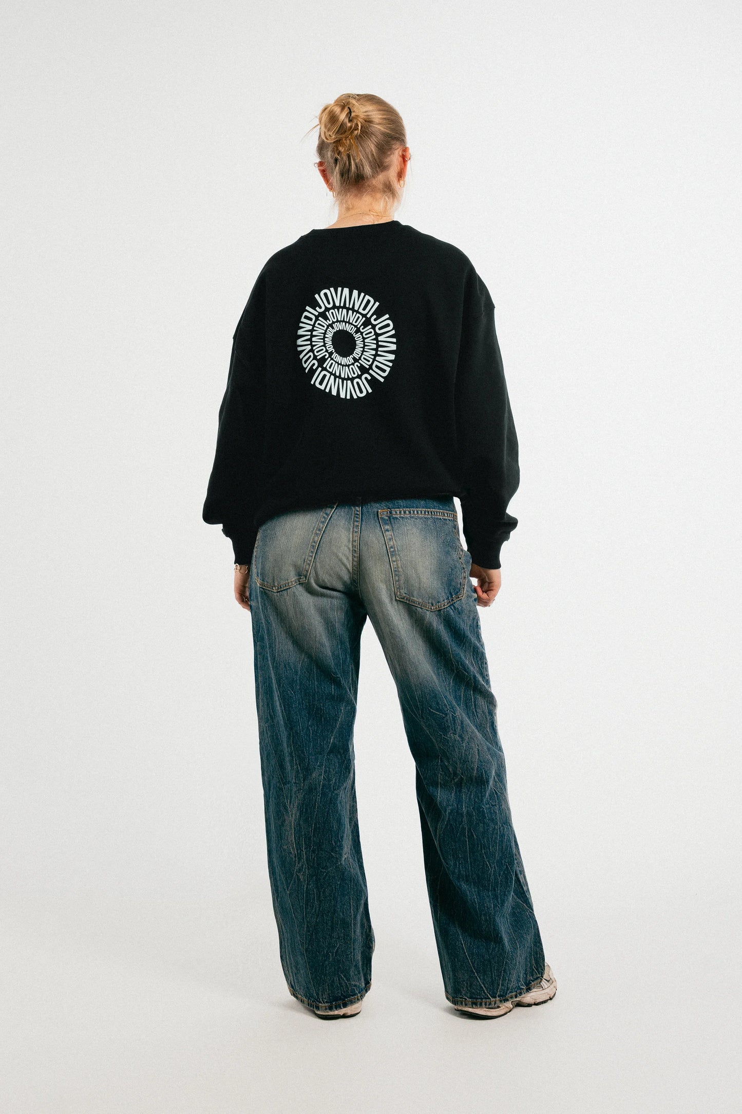 Woman wearing the black Jovandi circle sweater