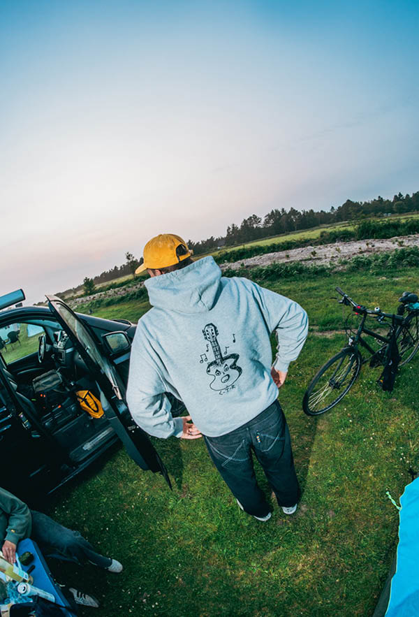 a guy with the guitar hoodie on a camping ground