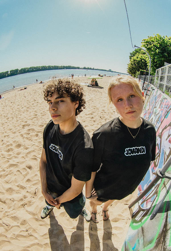 two people looking in the camera with the bouble tshirt