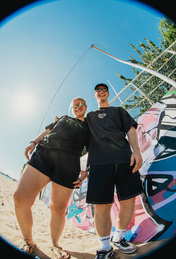 A girl and a guy standing arm in arm with the bouble and contrast tshirt from the front