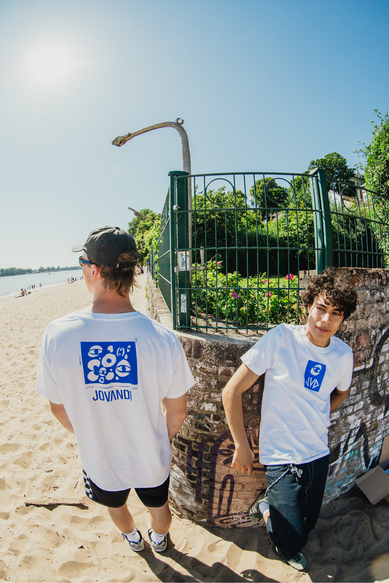 Two guys standing on the beach wearing the cheyes tshirts
