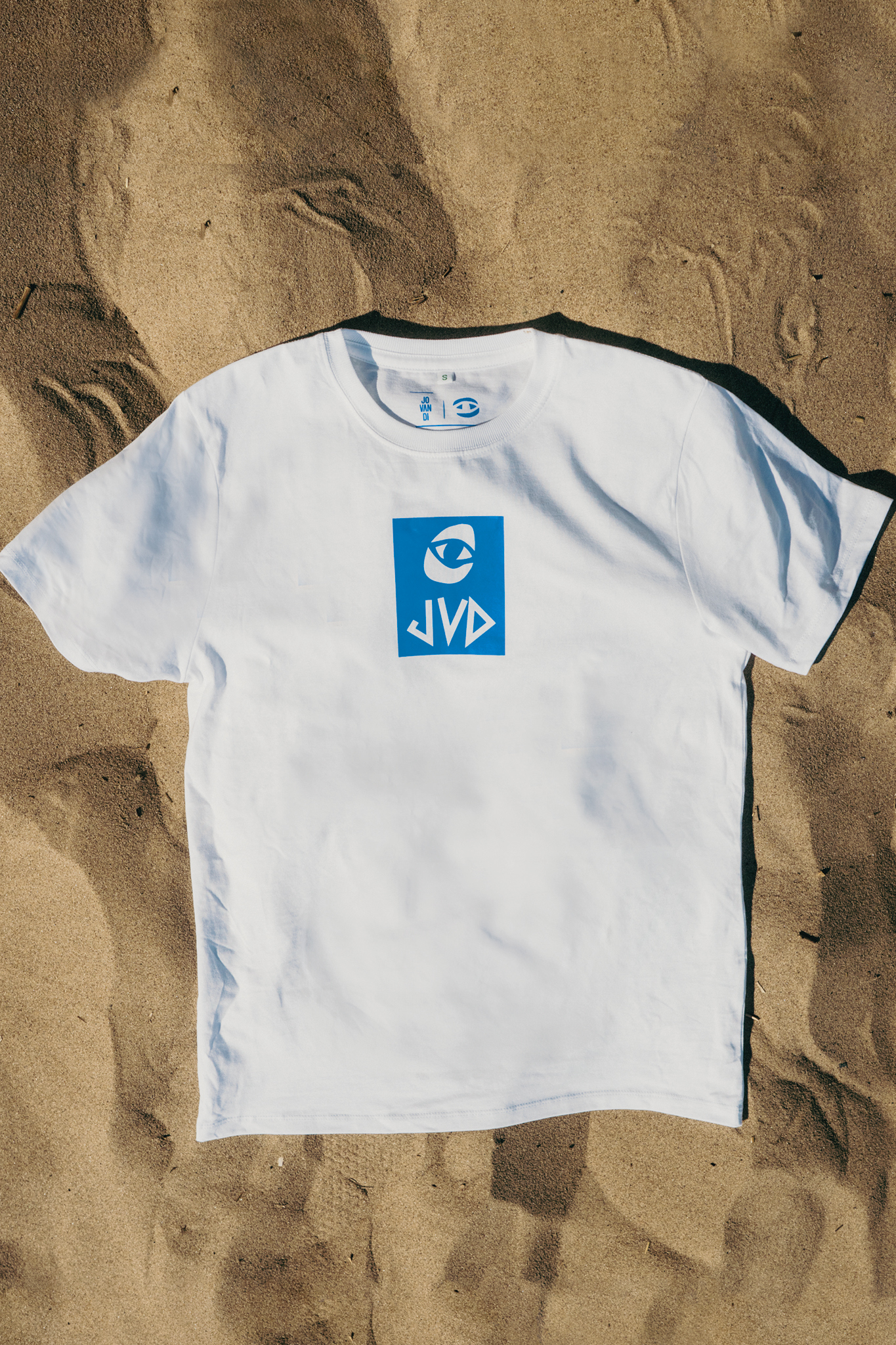 Flatlay of the Cheyes 2 T-Shirt on the beach